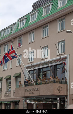Celebrating raising the Union Jack on the Pomme d'Or balcony  Liberation Day Parade at St Helier Stock Photo