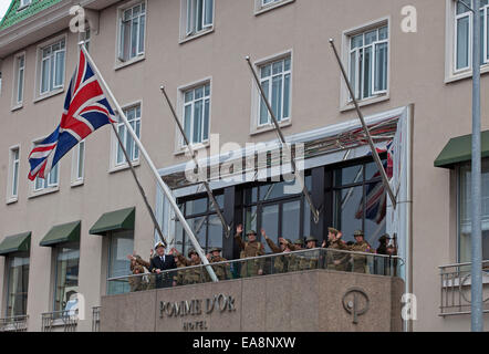 Celebrating raising the Union Jack on the Pomme d'Or balcony  Liberation Day Parade at St Helier Stock Photo