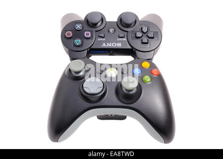 BARCELONA, SPAIN - APR 18, 2014: The DualShock 3 wireless controller, in front of its big rival of Microsoft Xbox 360. Stock Photo