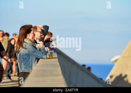 BARCELONA - MAY 30: Woman from the audience watches a concert a drinks a beer at Heineken Primavera Sound 2014 Festival (PS14). Stock Photo
