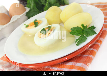 a plate with mustard eggs and potatoes Stock Photo