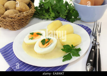 a plate with mustard eggs and potatoes Stock Photo