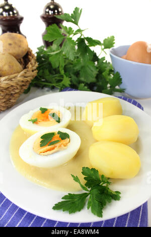 a plate with mustard eggs and potatoes Stock Photo