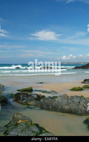 Rock pools at low tide on the beach at Newquay with view across Newquay Bay to Trevose Head on the North Cornish Coast Restormel Stock Photo