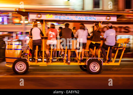 People enjoying a Booze bicycle tour on Lower Broadway at night in Nashville Tennessee Stock Photo