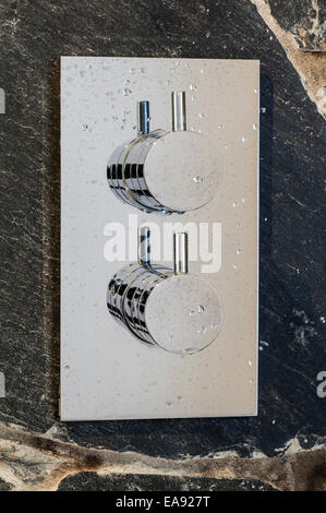 Modern chrome shower controls with water droplets Stock Photo