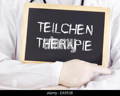 Doctor shows information: particle therapy in german language Stock Photo