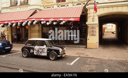 Vilniaus street, Vilnius, Lithuania. Mini car near pub. Stock Photo