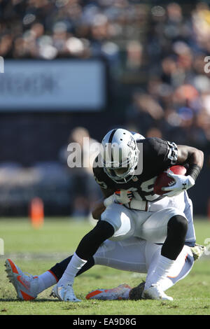 November 9, 2014: Oakland Raiders wide receiver Kenbrell Thompkins (85) is tackled after catching the football during the first half of the NFL football game between the Denver Broncos and the Oakland Raiders at the O.co Coliseum in Oakland, California. The Denver Broncos lead the Oakland Raiders at halftime 20 to 10. Stock Photo