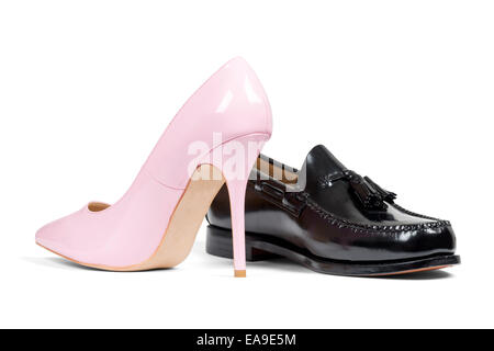 Luxury man's shoe and pink women's heel shoe isolated over white with clipping path. Stock Photo