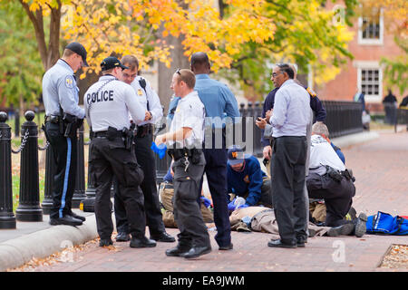 Police and EMS helping crime victim lying on ground - Washington, DC USA Stock Photo