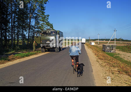 Autumn harvest field. Evening sunlight road. Stock Photo