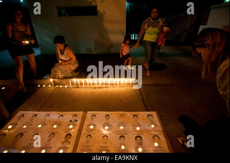 Santiago, Chile. 9th Nov, 2014. People put candles on the ground during a vigil for the disappearance of the 43 students of the Normal Rural School of Ayotzinapa, in front of Mexico's embassy in Chile, Santiago, capital of Chile, on Nov. 9, 2014. © Jorge Villegas/Xinhua/Alamy Live News Stock Photo