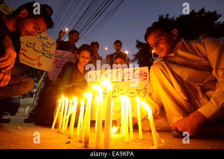 Lahore. 2nd Nov, 2014. Pakistani citizens hold placards during a protest against the suicide bomb blast on Wagah border in eastern Pakistan's Lahore on Nov. 9, 2014. More than 50 people were killed and over 100 others injured in a suicide blast that took place near Wagah crossing point on Pakistan and India border on Nov. 2, 2014, police officials said. © Sajjad/Xinhua/Alamy Live News Stock Photo