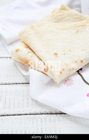 Pita bread on a napkin, white boards Stock Photo