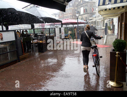 Cafes in the Markt (market place) Gouda, South Holland, The Netherlands during a torrential downpour of rain. Stock Photo