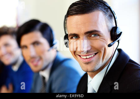 Smiling young businesspeople and colleagues in a call center office