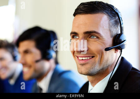 Attractive positive young businesspeople and colleagues in a call center office Stock Photo