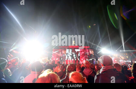 Berlin, Germany. 09th Nov, 2014. Spectators enjoying the celebrations at the Brandenburg Gate in Berlin, Germany, 09 November 2014. Numerous events celebrate the 25th anniversary of the fall of Berlin Wall. Photo: KAY NIETFELD/dpa/Alamy Live News Stock Photo