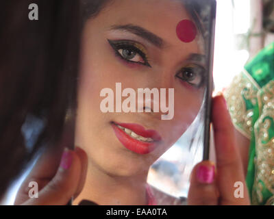 Dhaka, Bangladesh. 10th Nov, 2014. A transsexual watches the mirror during a colorful rally in Dhaka, Bangladesh, Nov. 10, 2014. Credit:  Shariful Islam/Xinhua/Alamy Live News Stock Photo