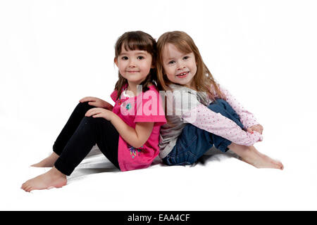 Two Adorable little girls isolated on white background Stock Photo