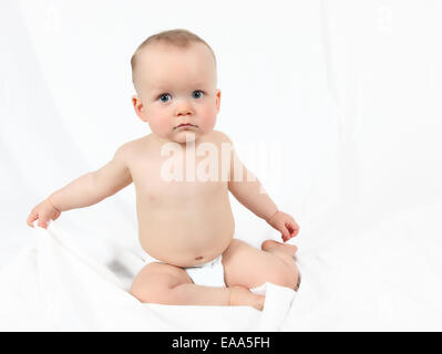 Cute baby boy posing for camera on white background Stock Photo