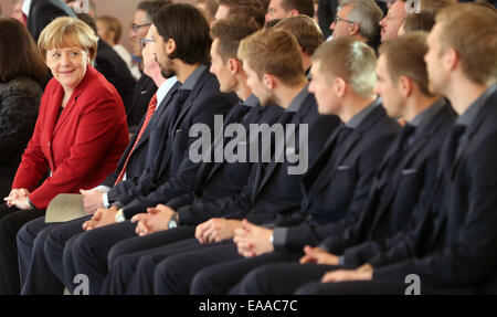 Berlin, Germany. 10th Nov, 2014. German Chancellor Angela Merkel (CDU) sits next to the national team soccer players at Bellevue Castle in Berlin, Germany, 10 November 2014. The German soccer national team is honored with the award 'Silbernes Lorbeerblatt' for winning the 2014 world cup in Brazil. Credit:  dpa picture alliance/Alamy Live News Stock Photo
