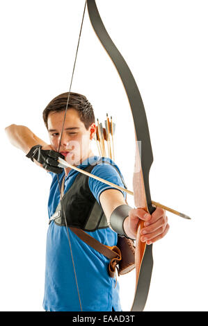 Boy with blue shirt and jeans shootling with a longbow Stock Photo