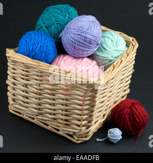 Colorful yarn basket isolated on black background Stock Photo