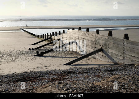 England, Sussex, West Wittering. Wooden groynes reduce longshore drift on open beaches. Stock Photo