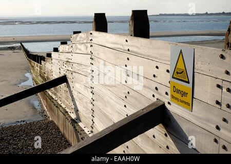 England, Sussex, West Wittering. Wooden groynes reduce longshore drift on open beaches. Stock Photo