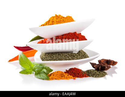 Studio shot with various kind of spices in ceramic bowls on white background Stock Photo