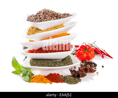 Studio shot with various kind of spices in ceramic bowls on white background Stock Photo