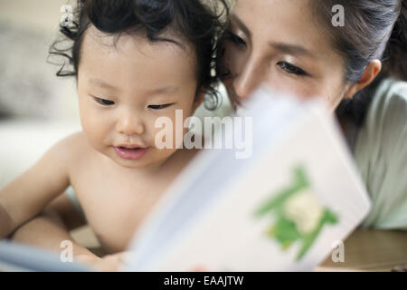 Mother reading to her baby boy. Stock Photo