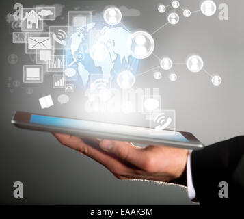 Business concept with manager holding tablet. Virtual icons around Stock Photo