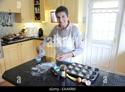 Elderly woman pensioner baking mince pies at home in her kitchen for Christmas Stock Photo