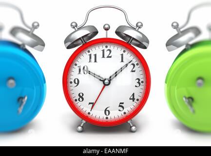 Red alarm clock front green and blue out of focus Stock Photo