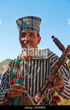 Vertical portrait of an old Moroccan man playing the traditional rebab. Stock Photo