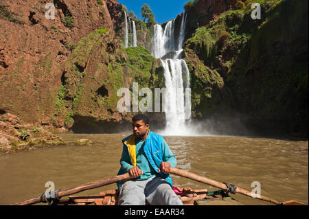 Horizonal portrait of a young Moroccan man rowing a tour boat at the bottom of Cascades d'Ouzoud Stock Photo