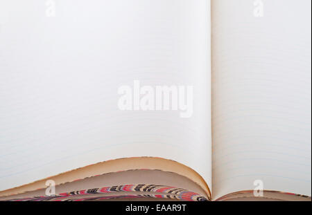Opened old yellowed notebook with blank lined pages Stock Photo