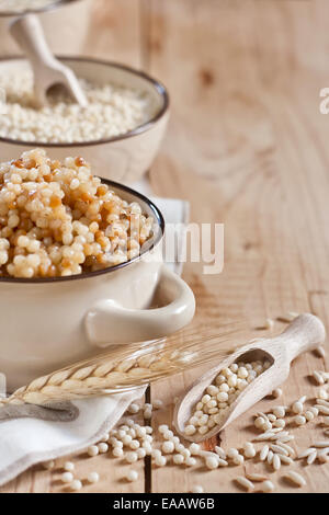 Ptititm or israeli couscous - kind of small pasta, traditional for israelian cuisine. Copy space background.
