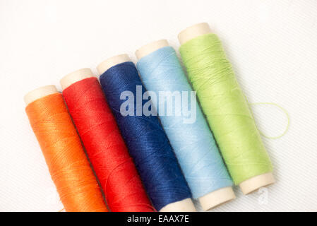 set of colorful spools of thread on a white background Stock Photo