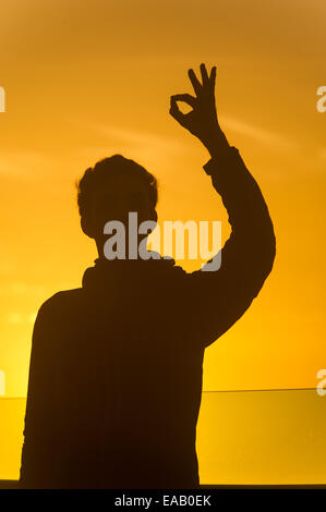 Ok hand sign silhouette at sunset Stock Photo - Alamy