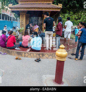 Cambodia, Siem Reap.  Worshipers at Shrine to Ya Tep, a Spirit (Neak-Ta) Who Brings Protection. Stock Photo