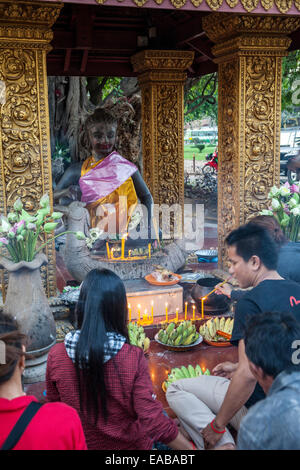 Cambodia, Siem Reap.  Worshipers at Shrine to Ya Tep, a Spirit (Neak-Ta) Who Brings Protection. Stock Photo