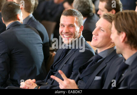 Berlin, Germany. 10th Nov, 2014. German national team soccer player Lukas Podolski laughs at Bellevue Castle in Berlin, Germany, 10 November 2014. The German soccer national team is honored with the award 'Silbernes Lorbeerblatt' for winning the 2014 world cup in Brazil. PHOTO: WOLFGANG KUMM/dpa/Alamy Live News Stock Photo