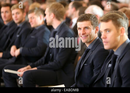 Berlin, Germany. 10th Nov, 2014. Thomas Mueller sits with the national team soccer players at Bellevue Castle in Berlin, Germany, 10 November 2014. The German soccer national team is honored with the award 'Silbernes Lorbeerblatt' for winning the 2014 world cup in Brazil. PHOTO: WOLFGANG KUMM/dpa/Alamy Live News Stock Photo