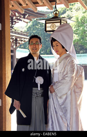 Tokyo, Japan - April 1, 2012: Married couple wearing traditional costumes during wedding ceremony at Meiji Shrine in Tokyo. Stock Photo