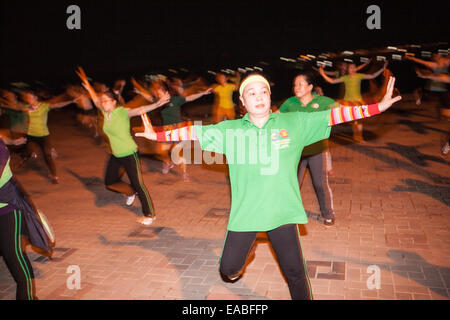 Group aerobics session on banks of Mekong River in centre of Vientiane, capital of Laos, South East Asia, Asia, Stock Photo