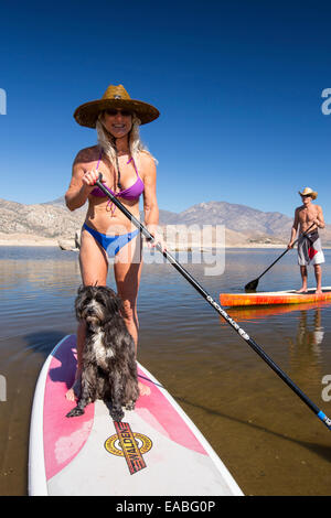 An elderly couple on stand on paddle boards on Lake Isabella near Bakersfield, East of California's Central valley which is at less than 13% capacity following the four year long devastating drought. The reservoir has dropped so low, that the water level is below the outflow pipe. Stock Photo